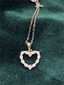 A Heart shaped pendant on a fine chain