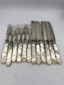 Set of six silver mounted knives and forks with mother of pearl style handles