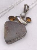 An unusual silver pendant necklace made up of a Druzi hardstone citrines and pearls.