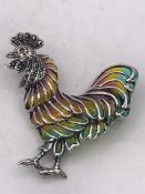 A Silver and Plique A Jour Cockerel Brooch