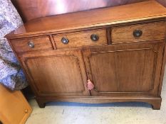 A three drawer over two cupboards sideboard with key.
