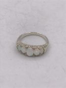 A silver ring set with five graduated opals