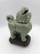 A Celadon Foo Dog on stand