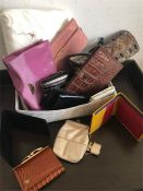 A large selection of purses, jewellery rolls and wallets.