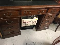 A pedestal desk with leather top.