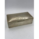 A silver cigarette box by Albert Sydenham, hallmarked Birmingham 1926.