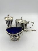 A hallmarked set of pepper pot, salt and mustard with blue glass liners