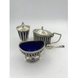 A hallmarked set of pepper pot, salt and mustard with blue glass liners