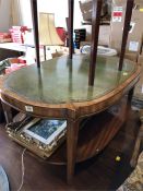 A Leather topped coffee table with shelf under