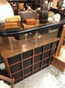 A Mid Century bar with black square design and curved Perspex.