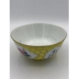 A 20th Century Chinese tea bowl with yellow grounds