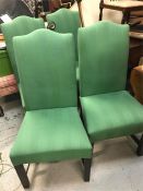 Four dining chairs in green.