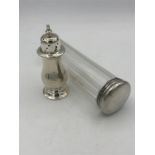 A silver pepper and silver topped faceted glass dressing table container and pepper pot, both