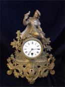 A small gilt clock, with a young child holding a bird.
