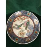 A 19th Century Chinese plate with hand painted design including birds.