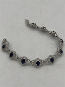 A silver CZ and Sapphire panelled bracelet.