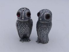 A Pair of 800 Continental silver owl condiments with glass eyes.