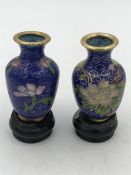 A pair of Cloisonné vases on wooden stands