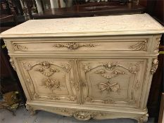 A Cream French style dresser with ornate front and top drawer with three drawers behind doors