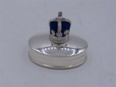 A silver pill box with a crown pin cushion to the lid.
