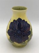 A Moorcroft vase, 13cm, yellow grounds blue, purple and pink flowers.