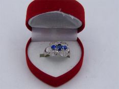 An 18ct white gold sapphire and diamond cluster ring.