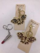 Two Butterfly and one lipstick handbag/keyring charms.