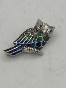 A silver and enamel set owl brooch with ruby eyes