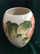 A Moorcroft vase, cream with peach flowers 18cm tall