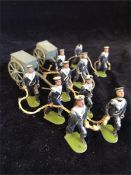 A set of Vintage lead navy figures pulling gun carriages.
