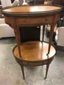 A pair of side tables with galleried brass edging on reeded legs with castors.