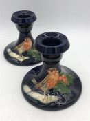 A Pair of Moorcroft Christmas themed candlesticks 8cm