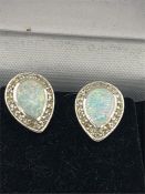 A pair of silver CZ and Opal set earrings