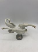 Three Lladro geese.