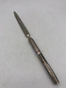 A silver handled calendar letter opener.