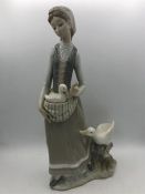 A Lladro figure of a lady with ducks or geese?