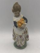 Lladro figure of a girl carrying oranges.