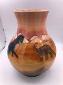 A Moorcroft Dinosaur themed vase 132/300 24cm tall.