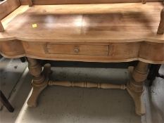 An antique Pine was stand with small central drawer to the front