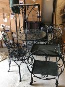 A selection of wrought iron garden furniture in green to include round table with four chairs, small