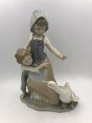 A Lladro figure of two children and a goose