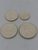 Four biscuit ware coins USA and Coronation.