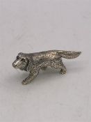 A cast silver figure of a dog