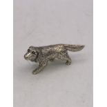 A cast silver figure of a dog