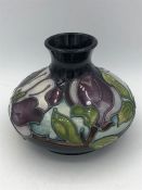 A Moorcroft dark blue and purple vase 10cm tall.