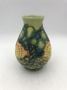 A Moorcroft 13cm tall vase themed on trees on a sunny day.