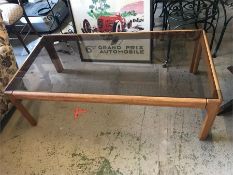 A Mid Century glass topped rectangular table.