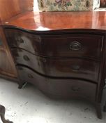 A Mahogany three drawer Serpentine fronted chest of drawers