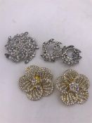 Two pairs of crystal brooches plus a large one