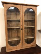 A pine four shelf glass fronted display cabinet